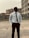 a man in a white shirt and tie standing in a parking lot