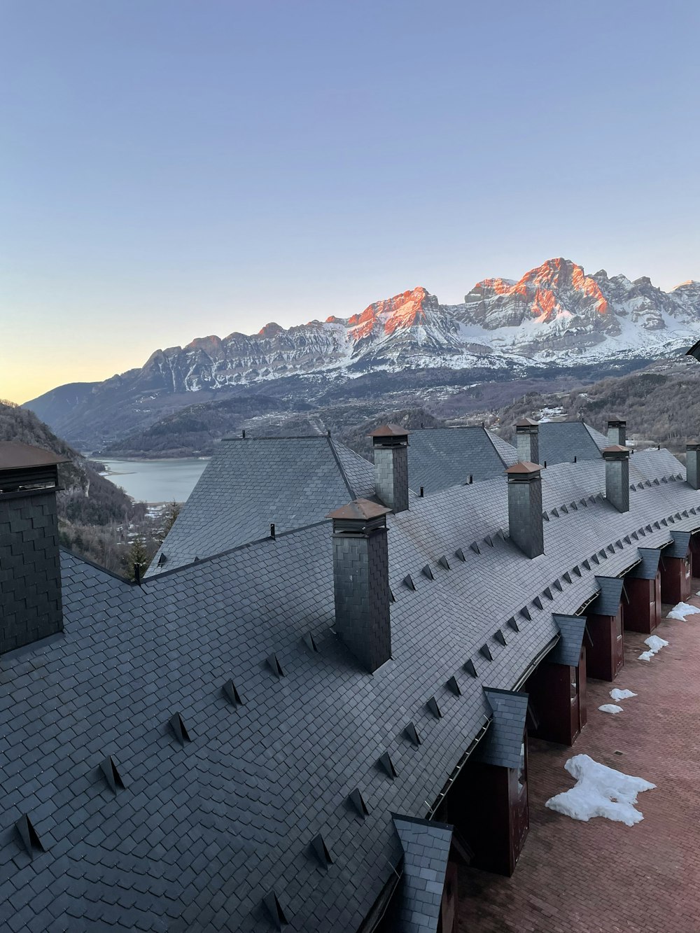 the roof of a building with mountains in the background