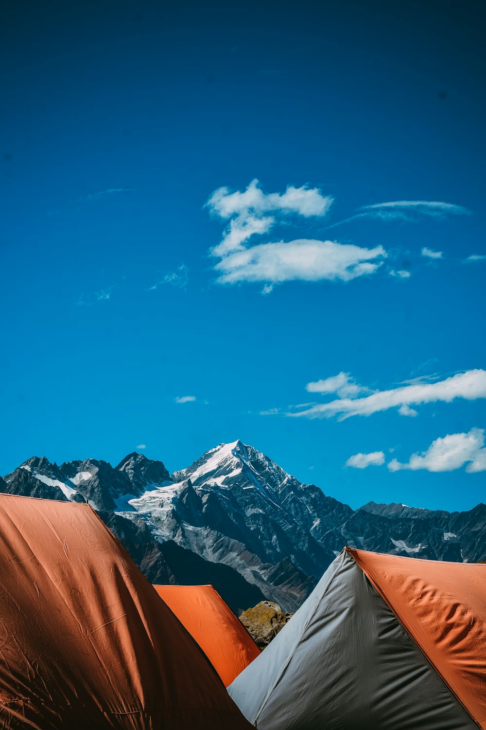 a couple of tents sitting in the middle of a field