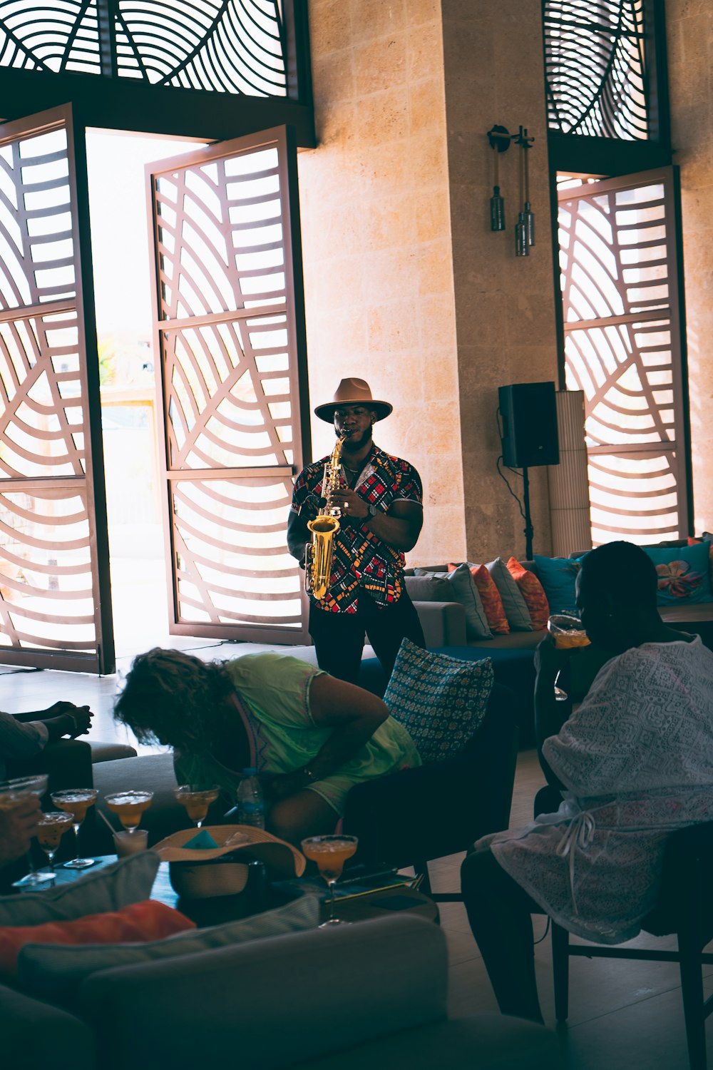 a man playing a saxophone in a living room