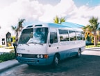 a white bus parked on the side of the road