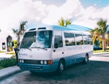 a white bus parked on the side of the road