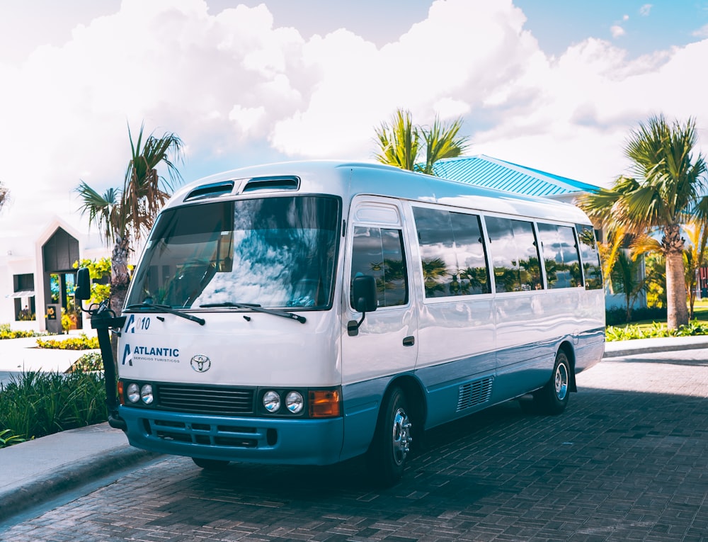 a white bus parked on the side of the road