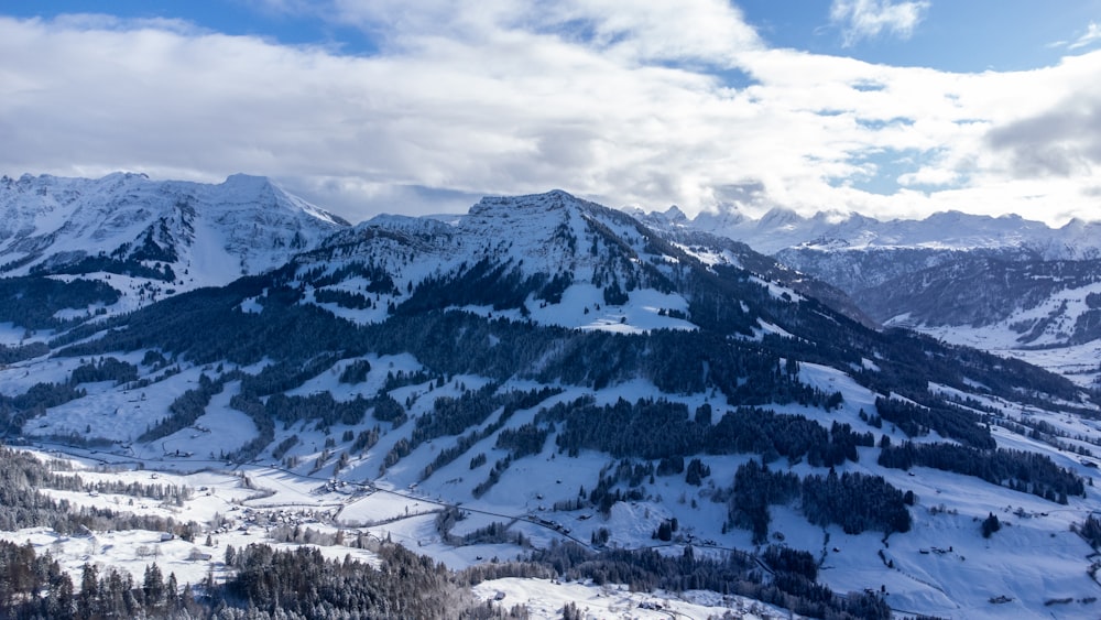 a view of a mountain range covered in snow