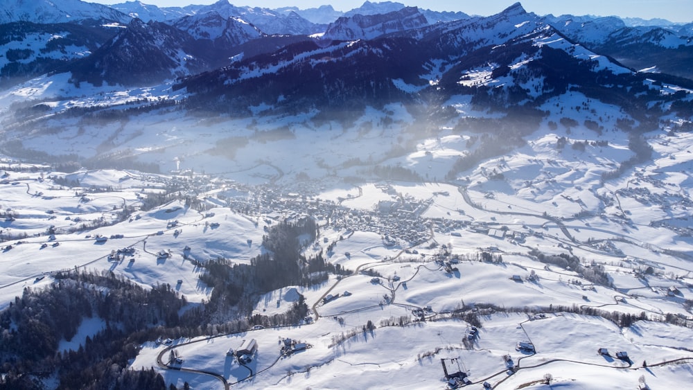 an aerial view of a snowy mountain range