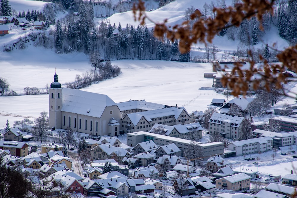 a snowy town with a church in the middle
