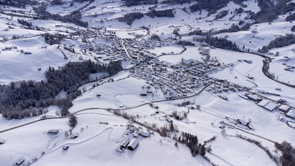 an aerial view of a town in the snow