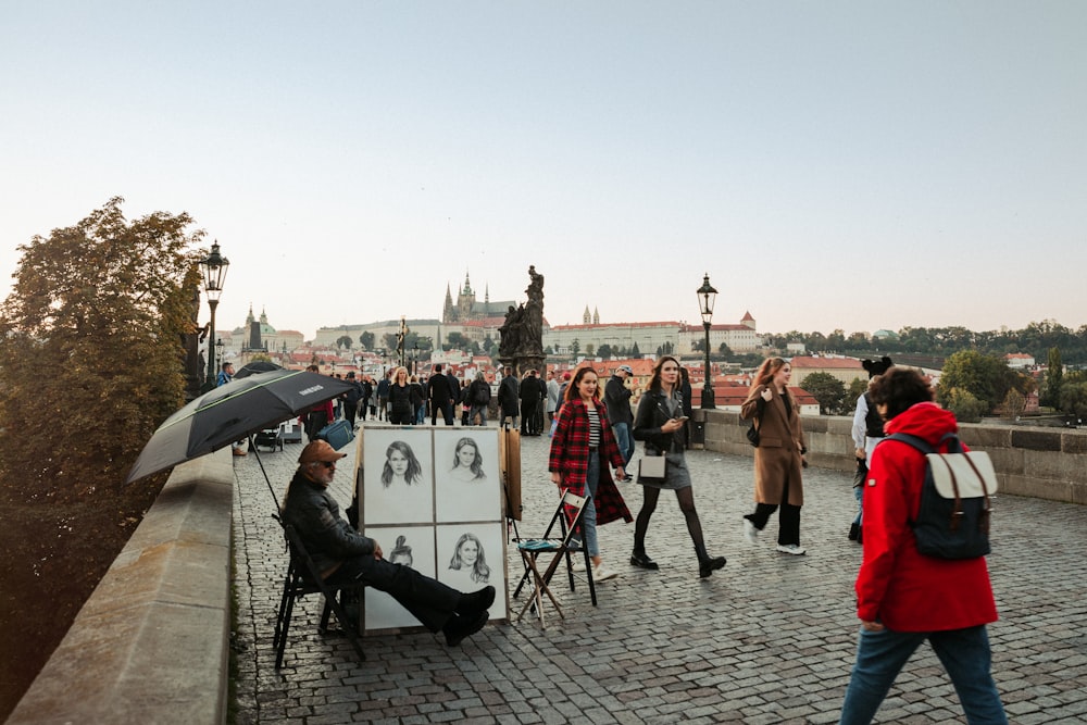 a group of people walking across a bridge