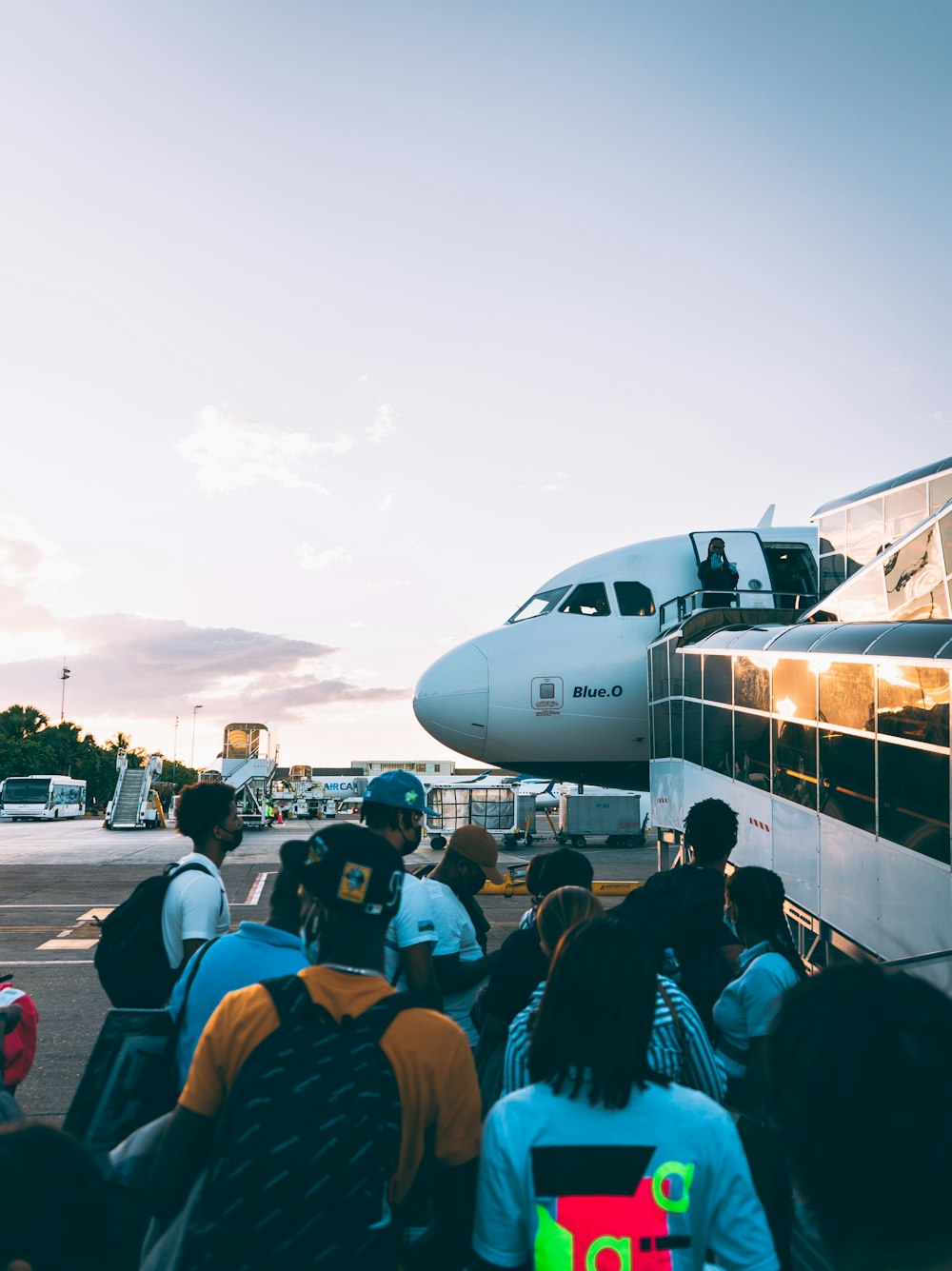 a group of people standing in front of an airplane