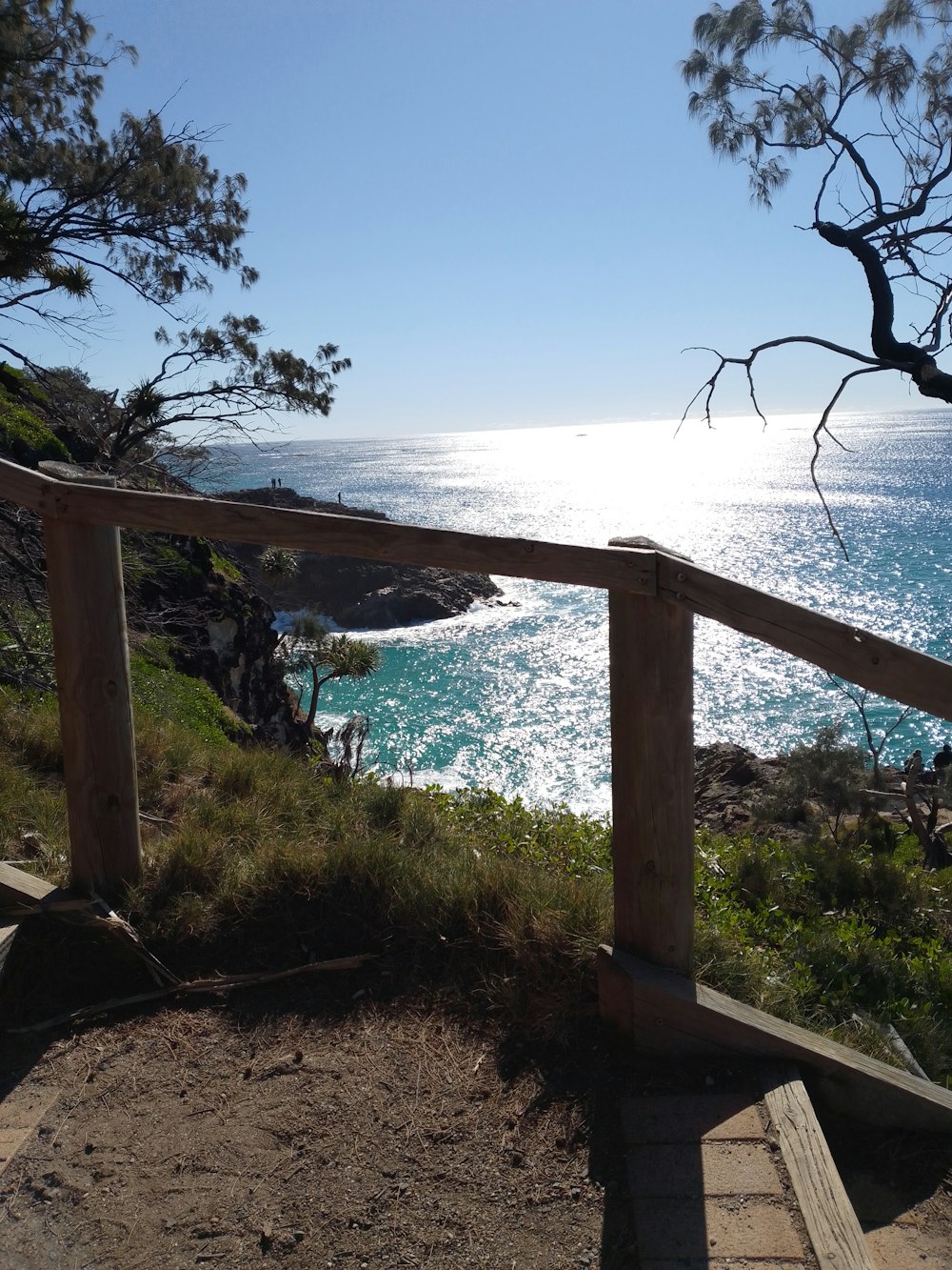 a view of the ocean from the top of a hill