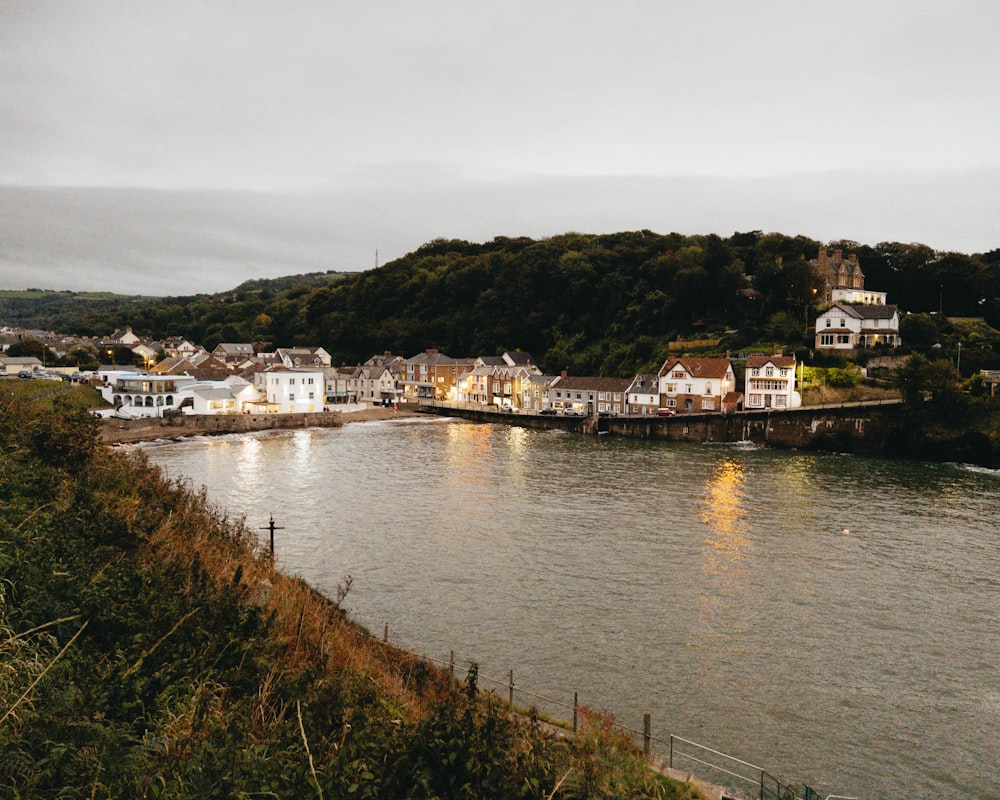 a body of water with houses on the shore