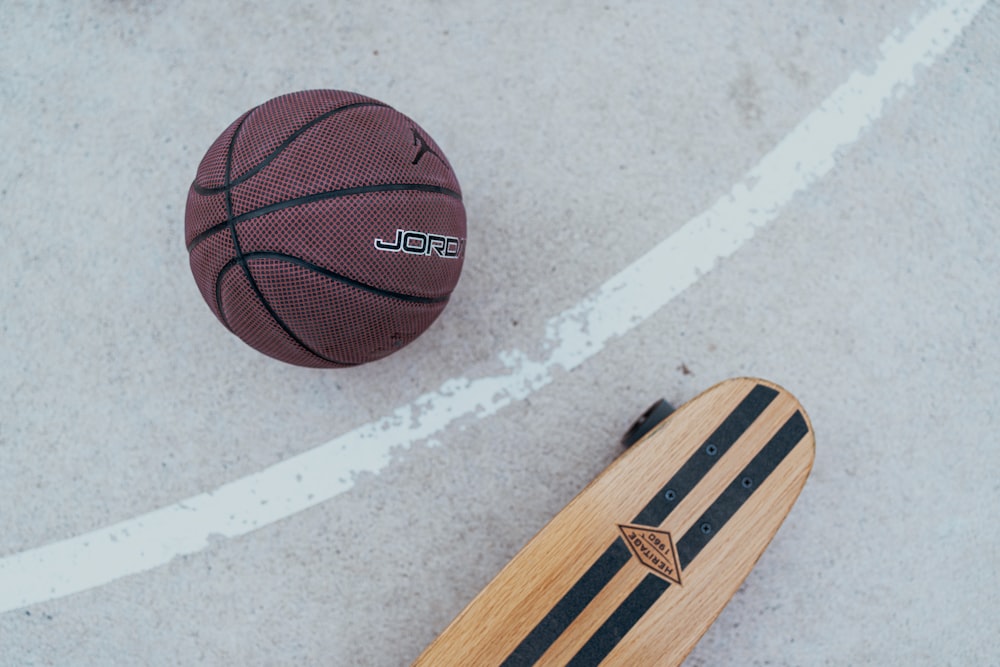 a skateboard and a basketball on the ground