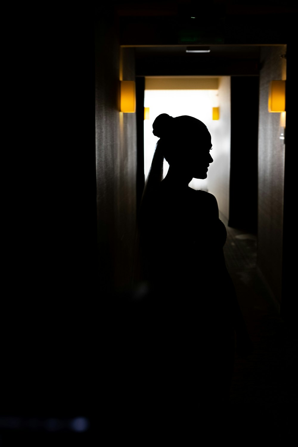 a silhouette of a woman in a dark room