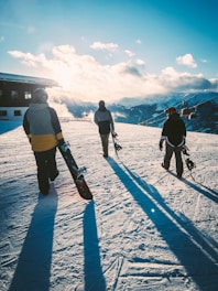 a group of people standing on top of a snow covered slope