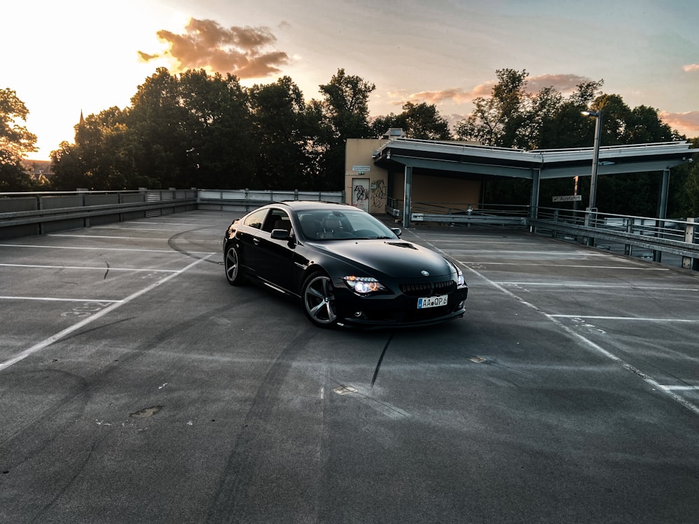 a black car parked in a parking lot