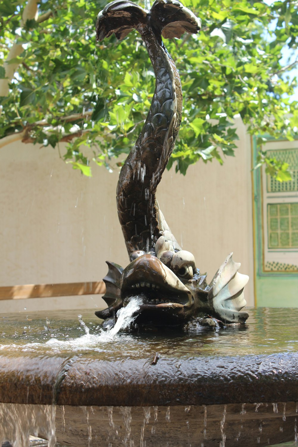 a fountain with a bird statue on top of it