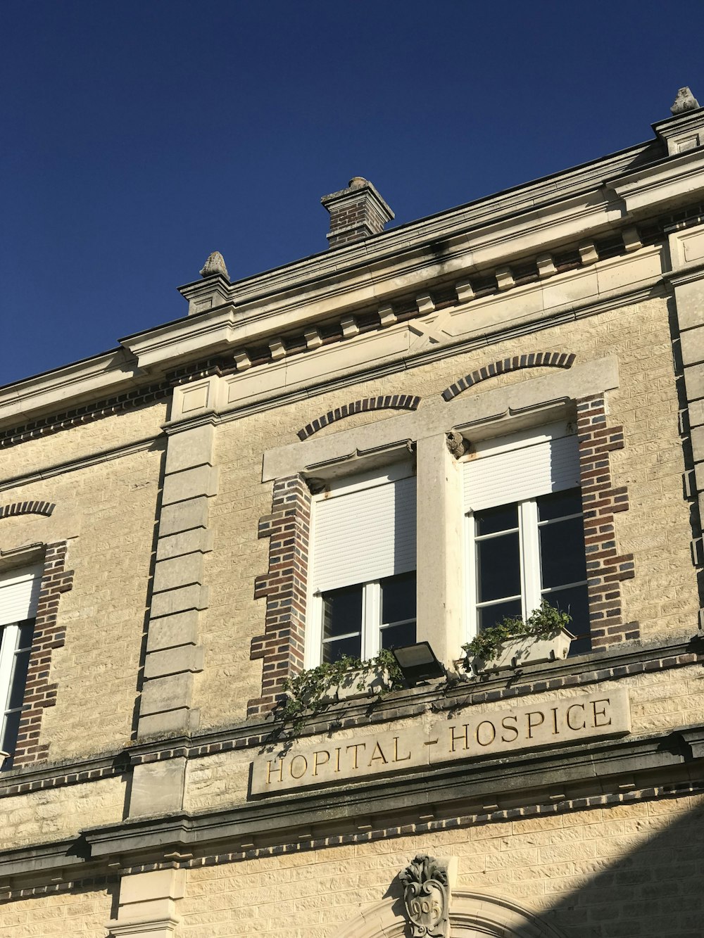 a building with two windows and a sign that says hospital hospital