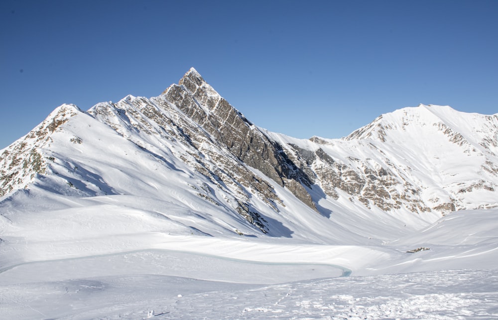 a person on skis standing on a snow covered mountain