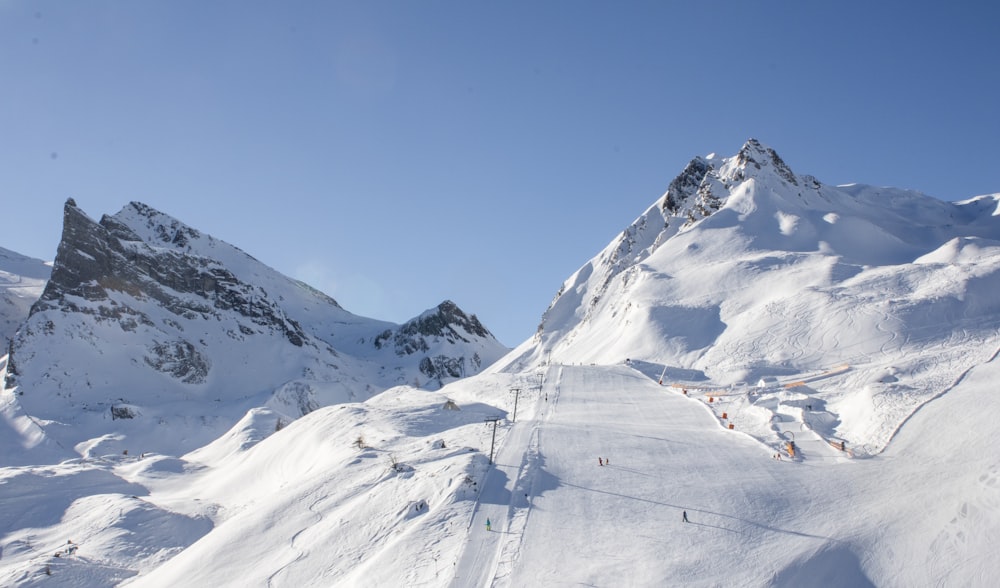 a snow covered mountain with a ski lift in the distance