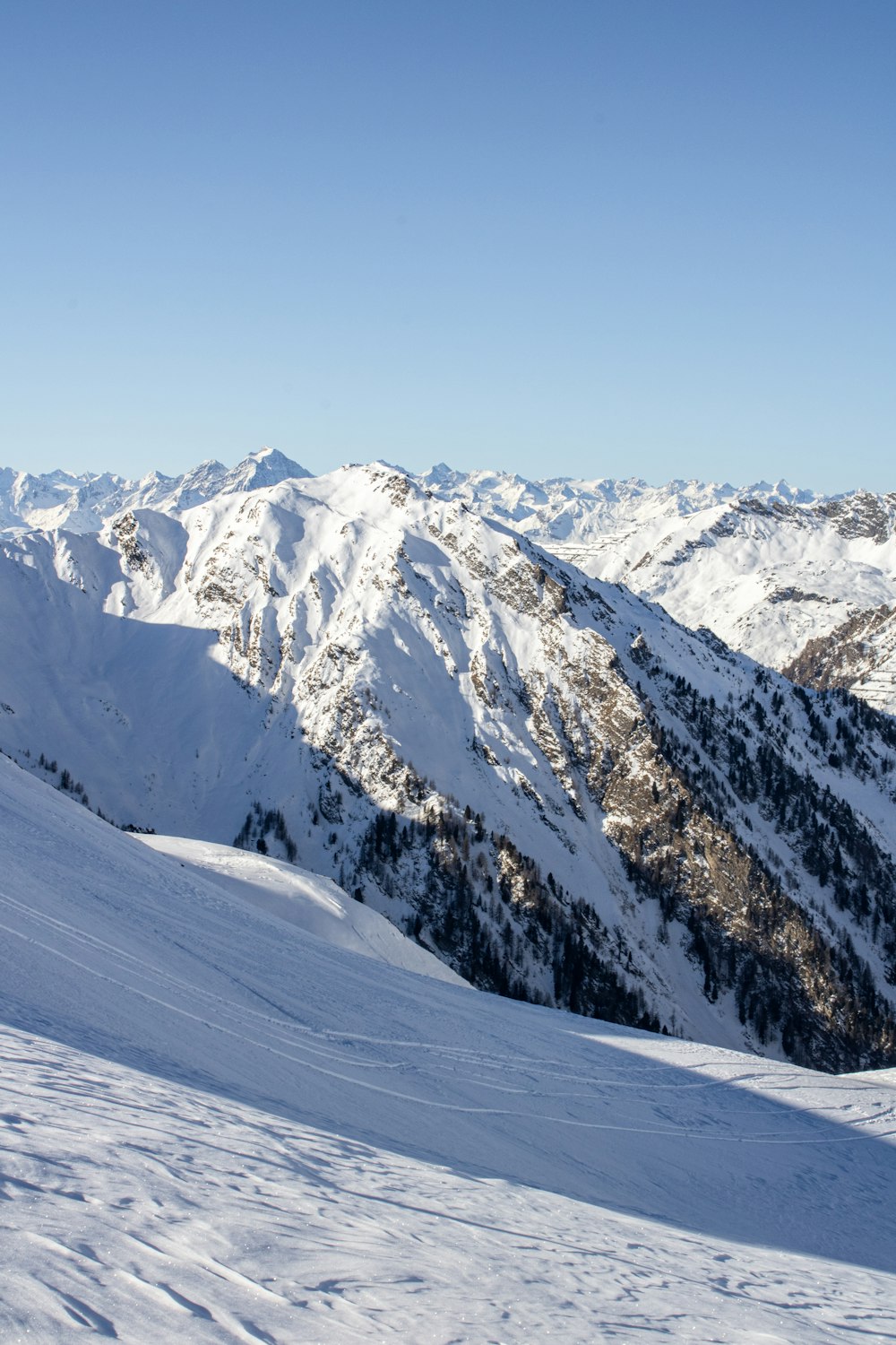 a man riding skis on top of a snow covered slope