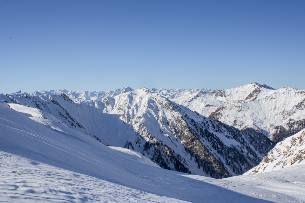 a man riding skis on top of a snow covered slope