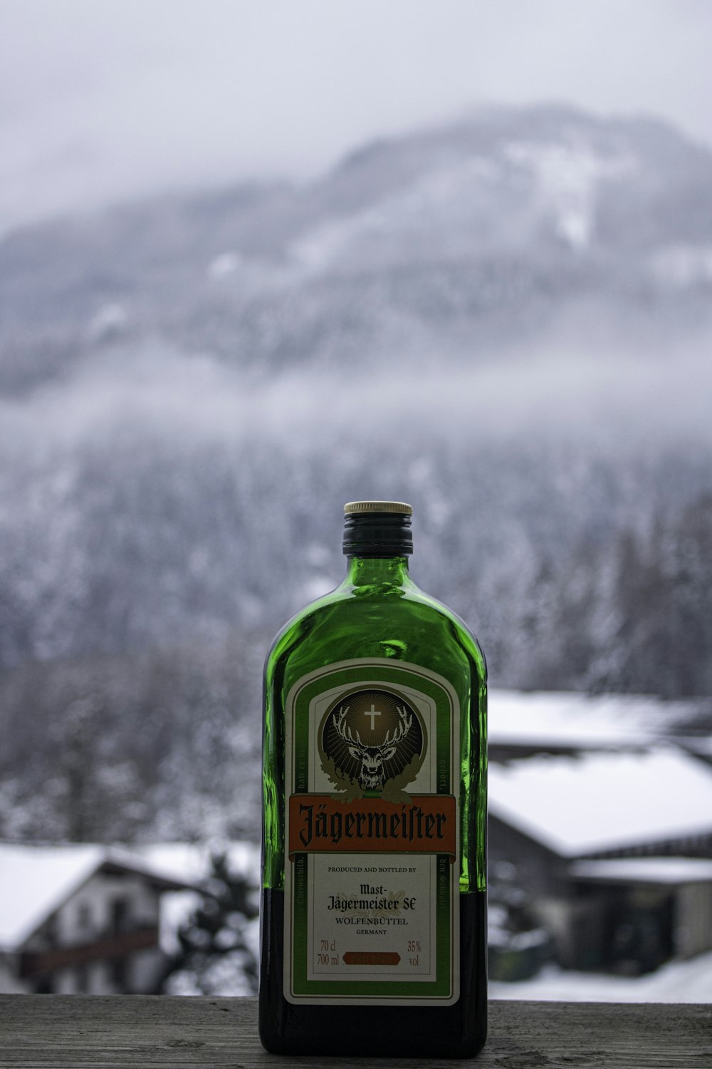 a bottle of alcohol sitting on top of a wooden table