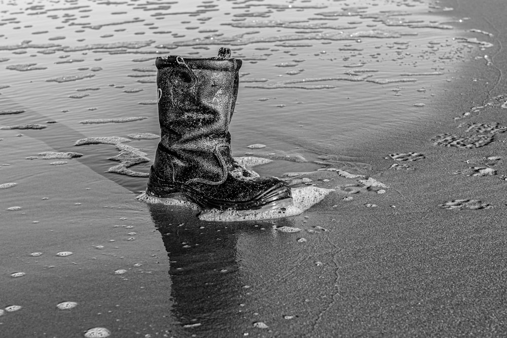 a pair of boots that are sitting in the sand
