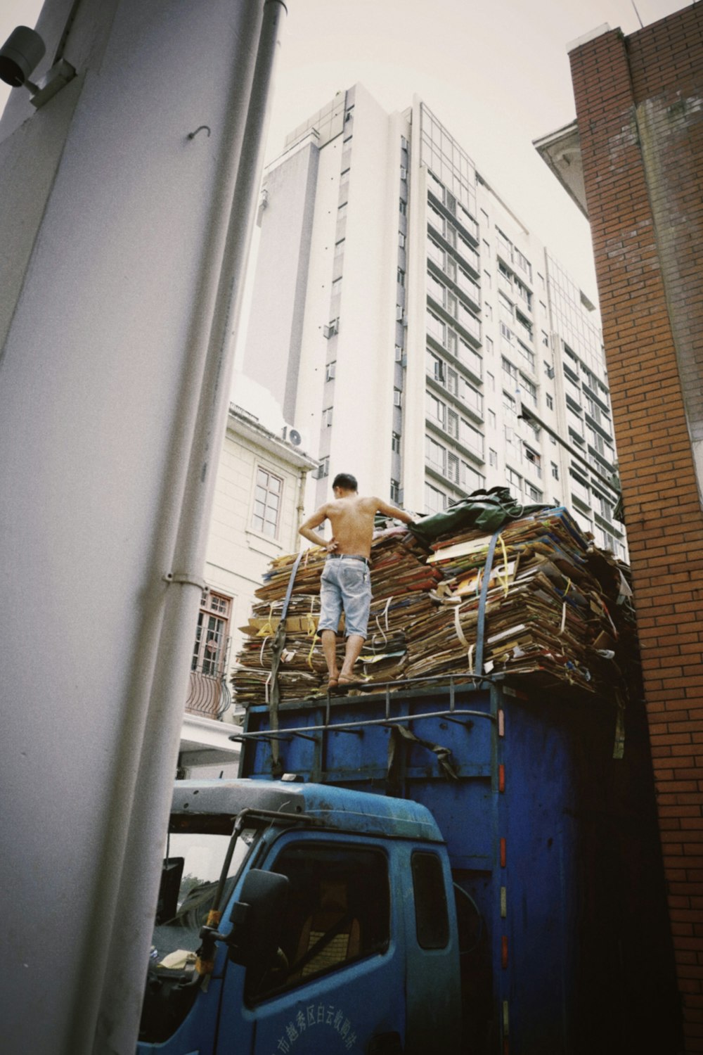 a man standing on top of a blue truck