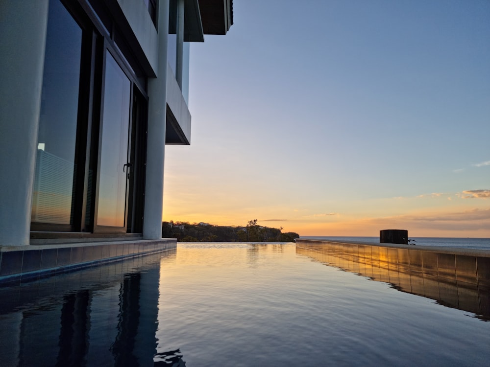 a large swimming pool next to a tall building