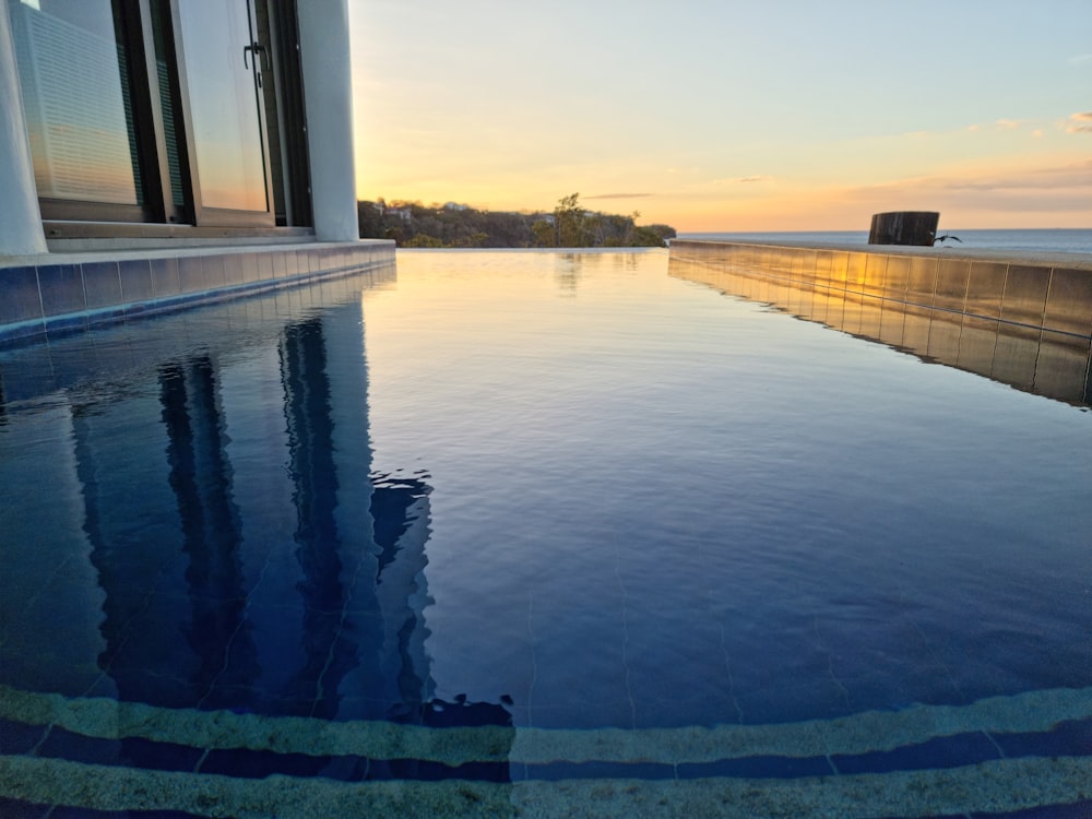 a large swimming pool with a view of the ocean