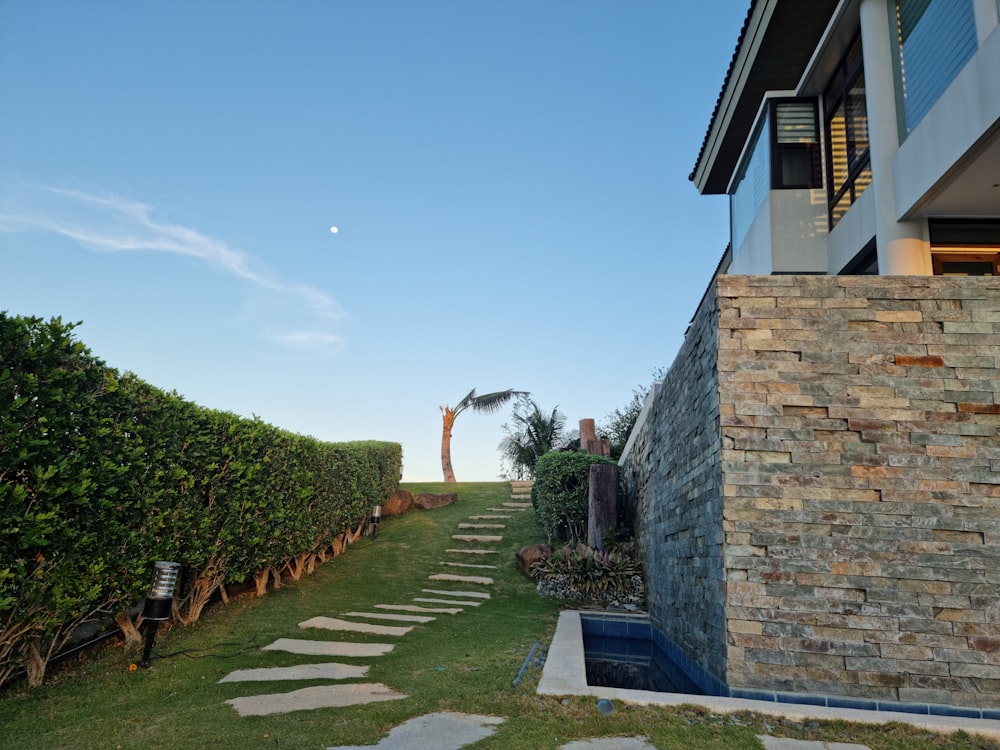 a stone path leading to a house on a hill