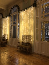 a room filled with lots of windows covered in lights