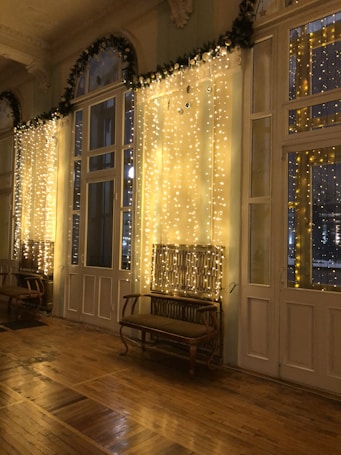 a room filled with lots of windows covered in lights