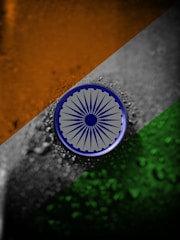 a picture of a indian flag with a blue circle on it