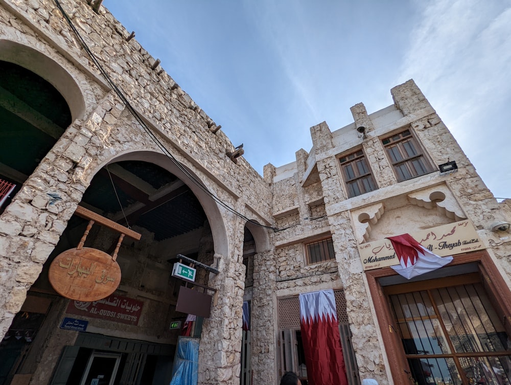 a stone building with a clock on the front of it