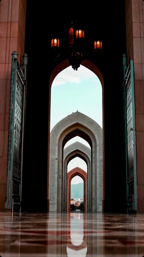 a large archway with a clock on top of it