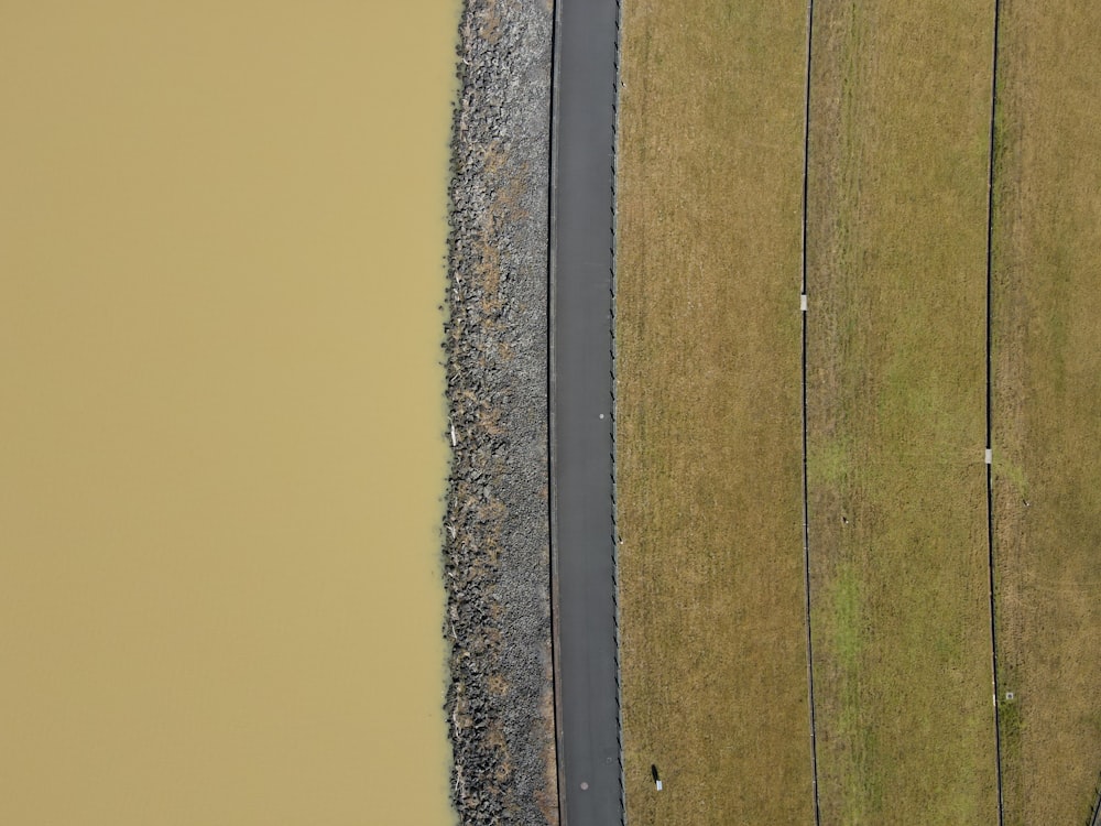 a bird's eye view of a road and a field