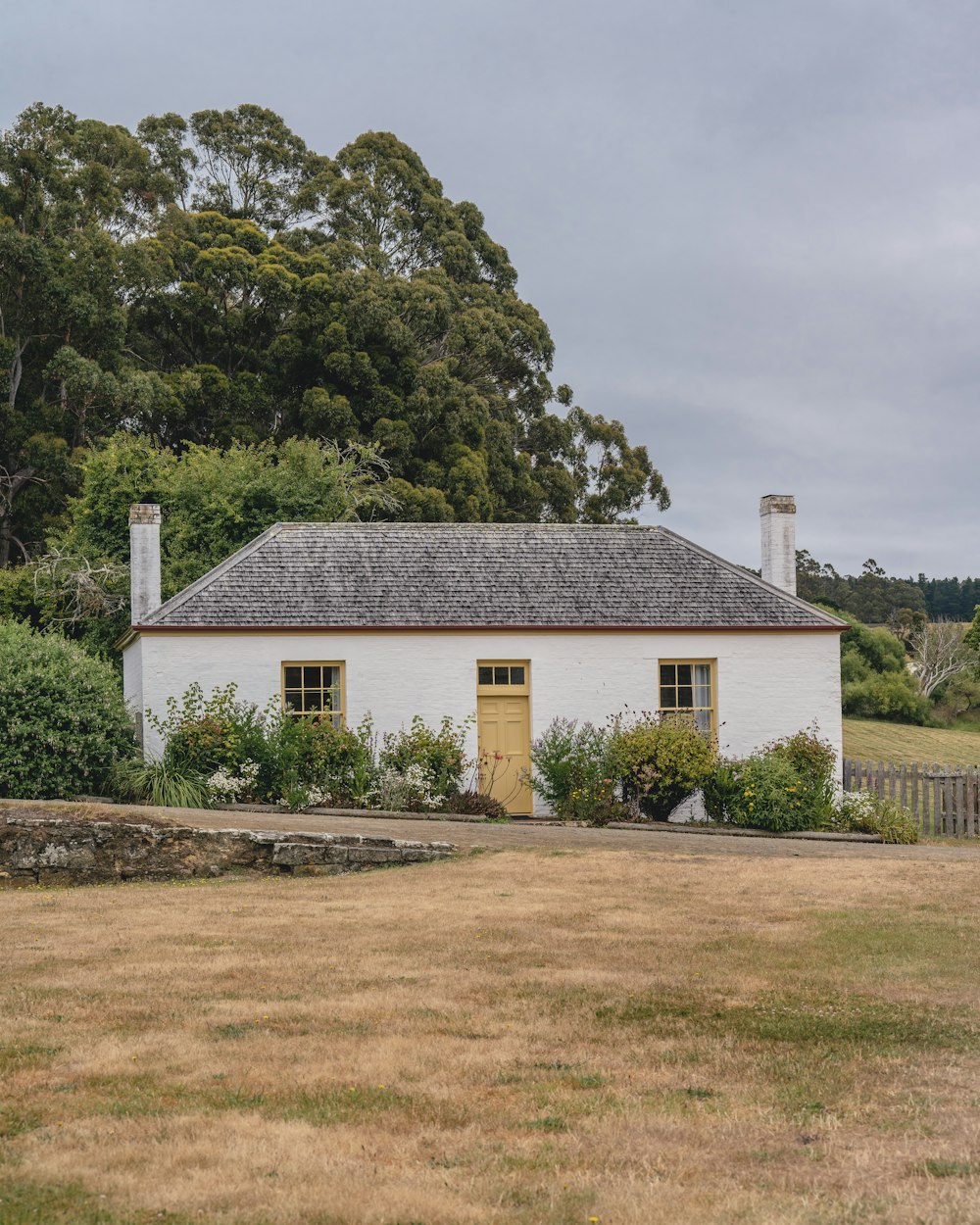 a white house with a yellow door and windows