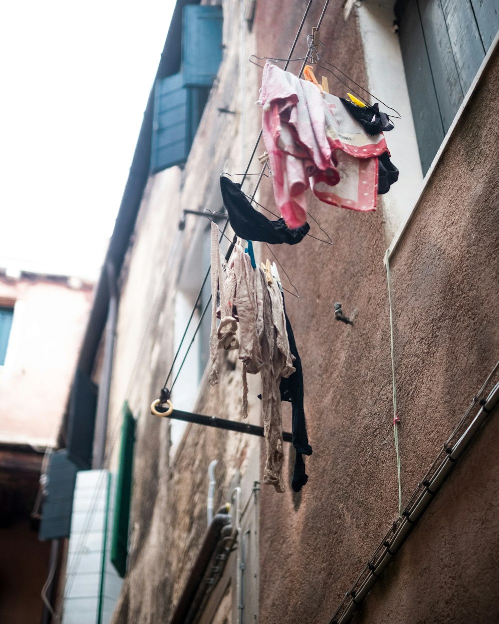 clothes hanging on a clothes line outside of a building