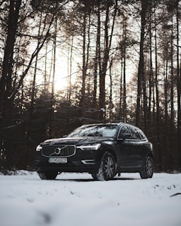 a volvo car is parked in the snow