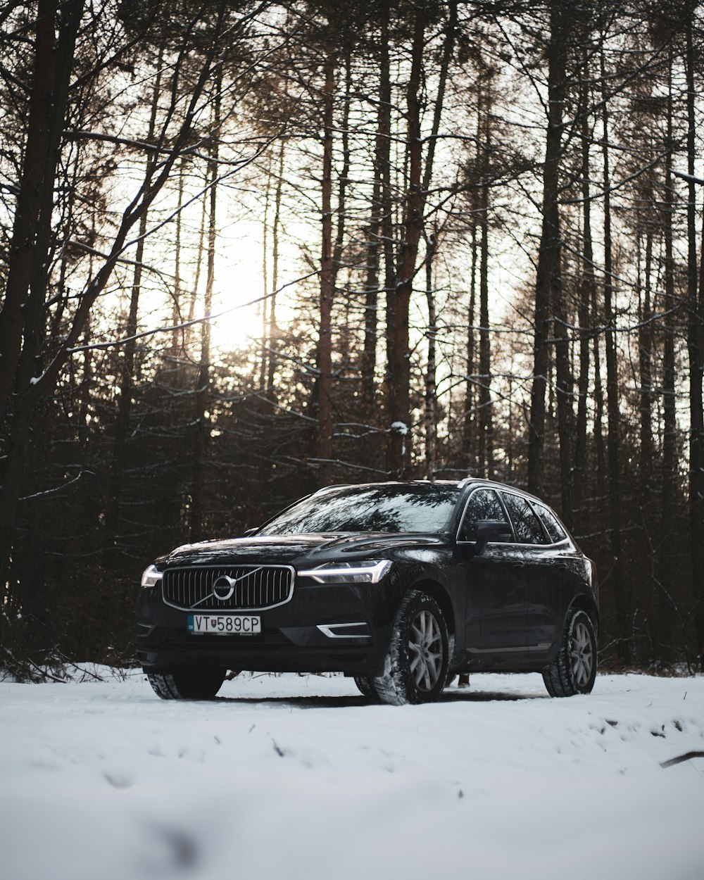 um carro volvo está estacionado na neve