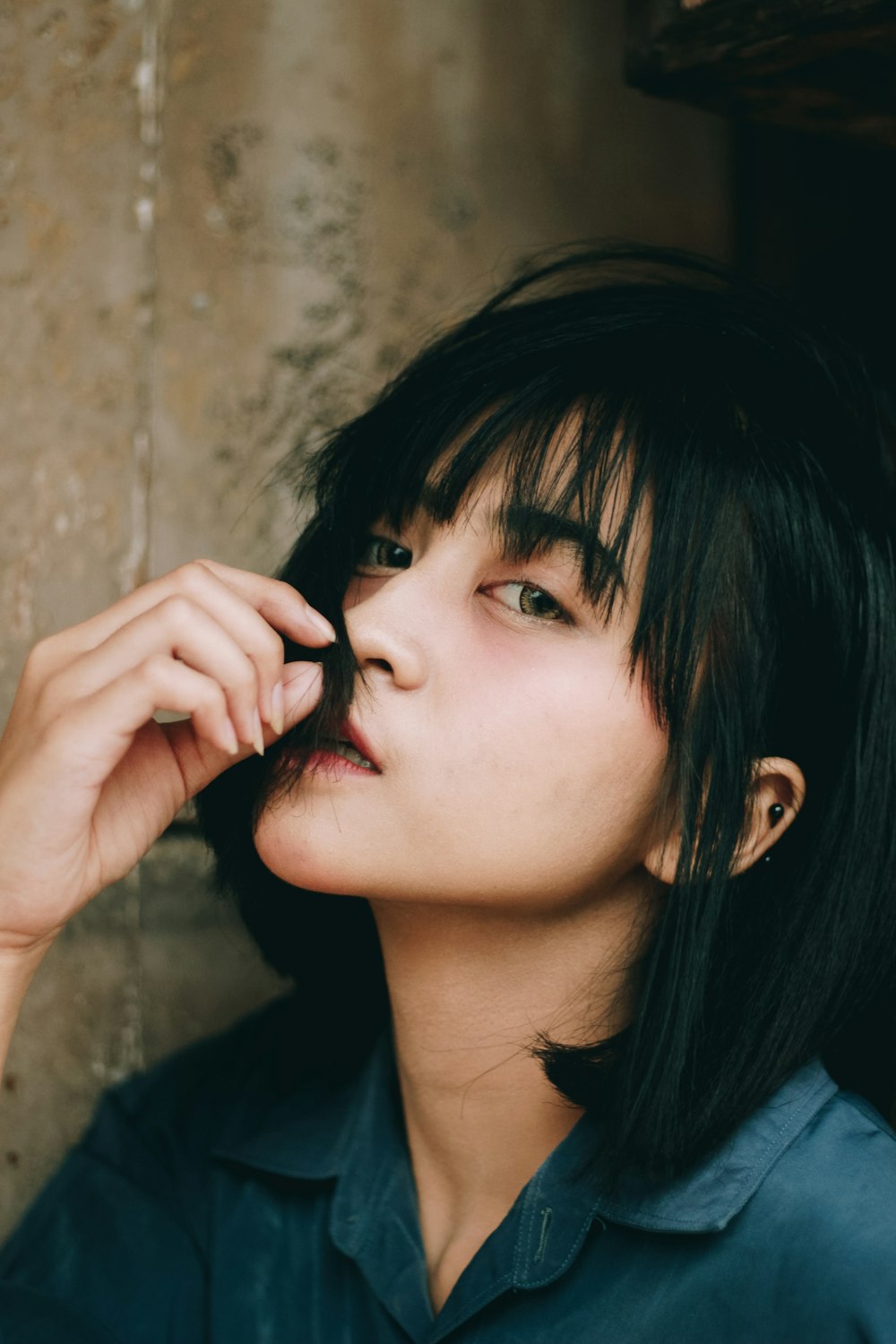 a woman with black hair and a blue shirt