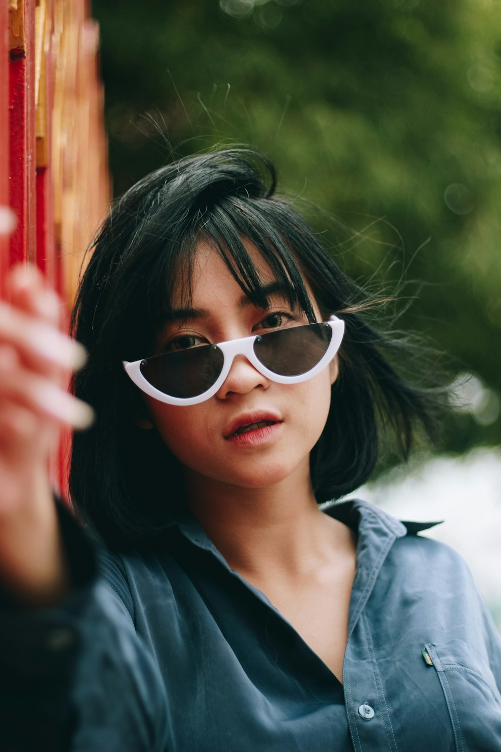 a woman wearing sunglasses and a blue shirt