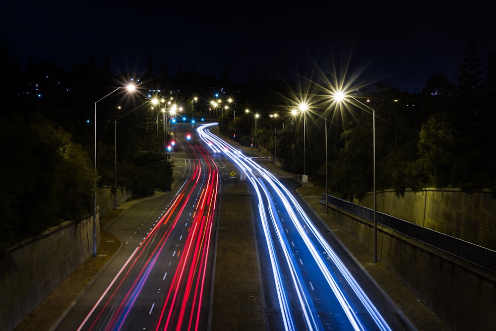 a long exposure photo of a highway at night