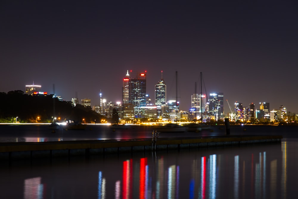 a city skyline is lit up at night