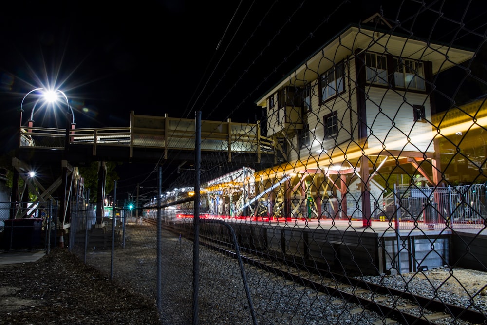 a train traveling past a train station at night