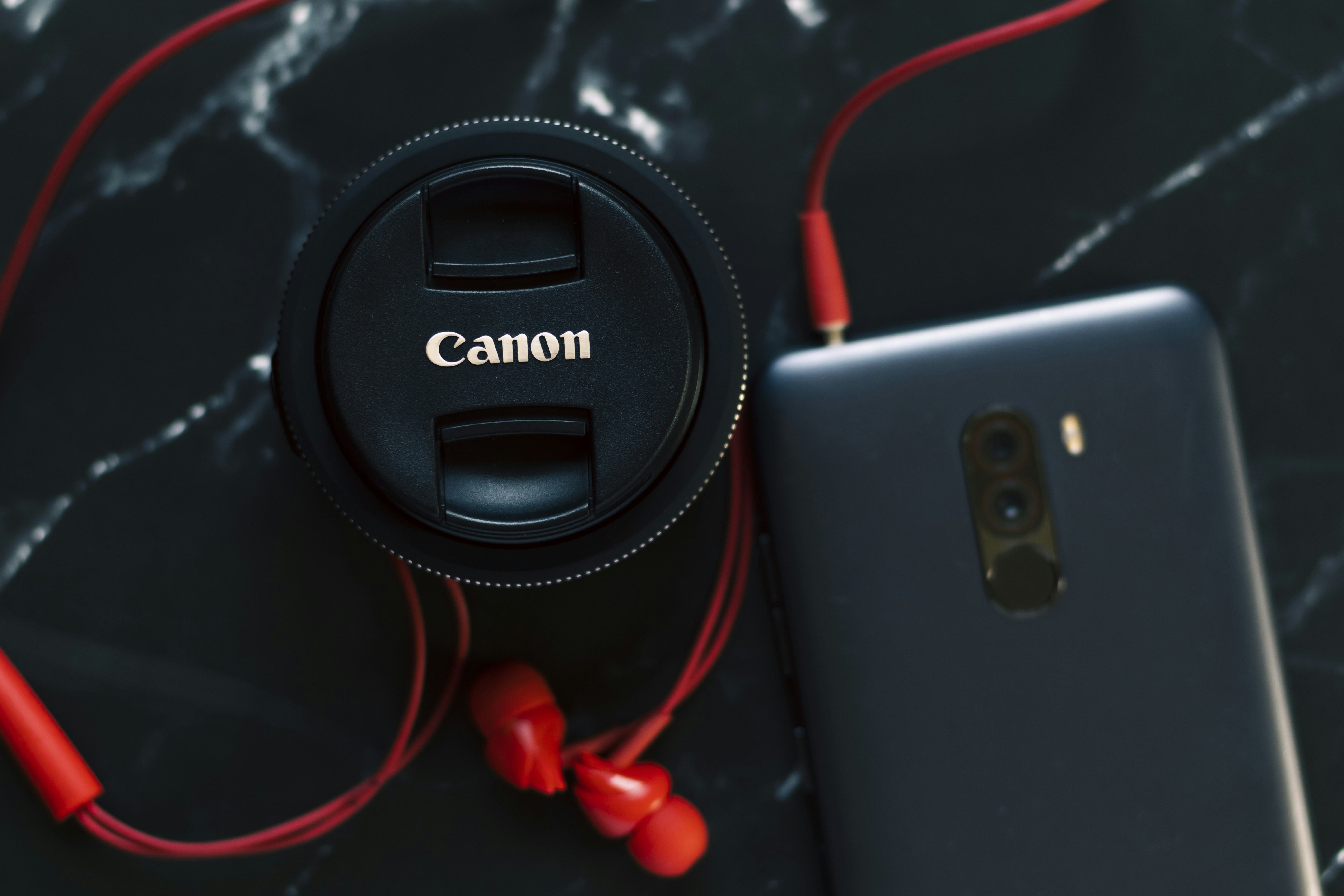 a camera and a cell phone on a table