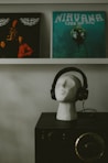 a head with a pair of headphones on top of it