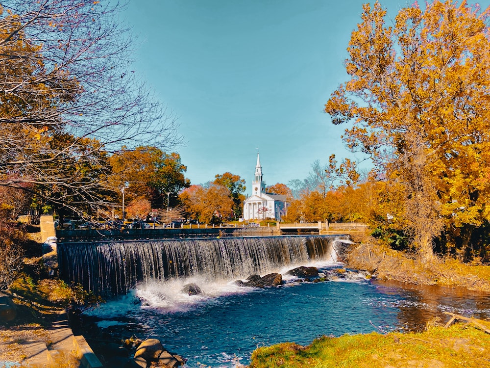 Ein Wasserfall mit einer Kirche im Hintergrund