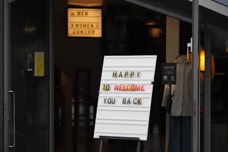 a sign that says happy to welcome you back